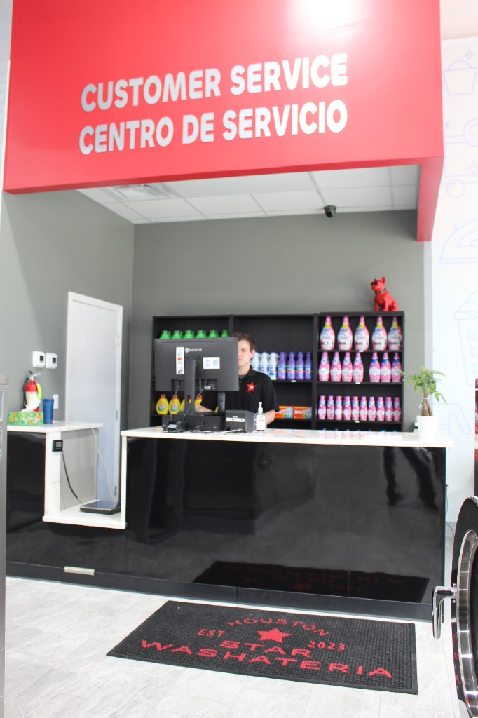 Customer service desk with laundry supplies and friendly staff